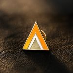 Geometric Orange Triangle Enamel Pin — front display view