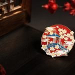 Red Pavilion and Blossom Enamel Pin — angled detail view
