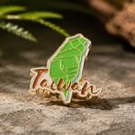 Taiwan Island Map Script Enamel Pin — angled detail view